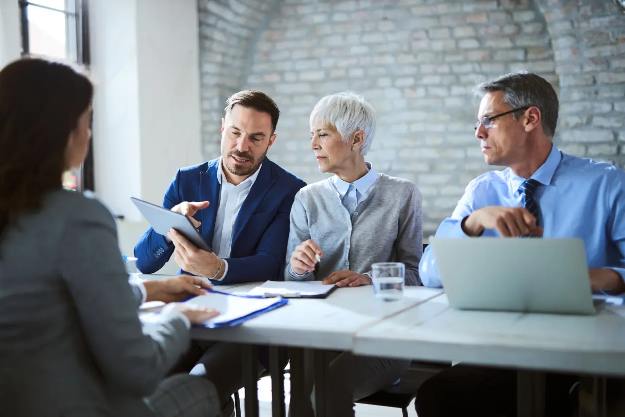 New Project (22) Business team discussing documents in a meeting room.