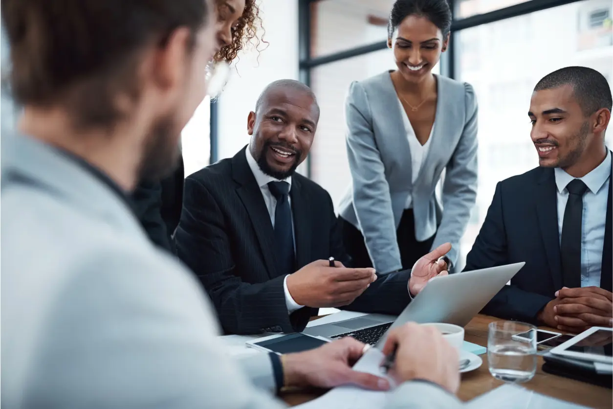 Three business professionals discussing work in a modern office.