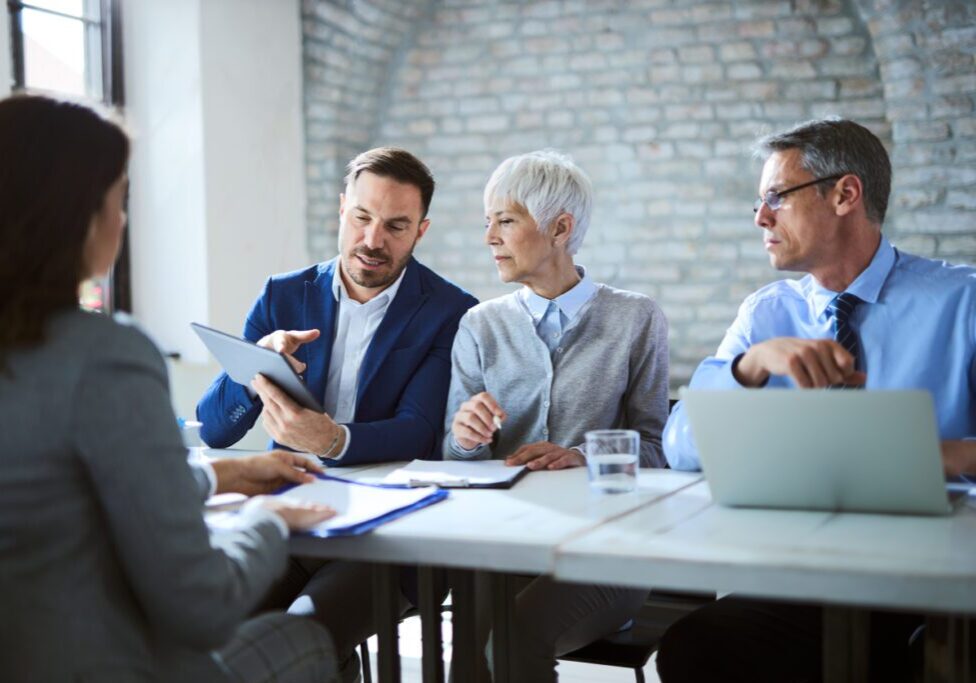 Business team discussing documents in a meeting room.